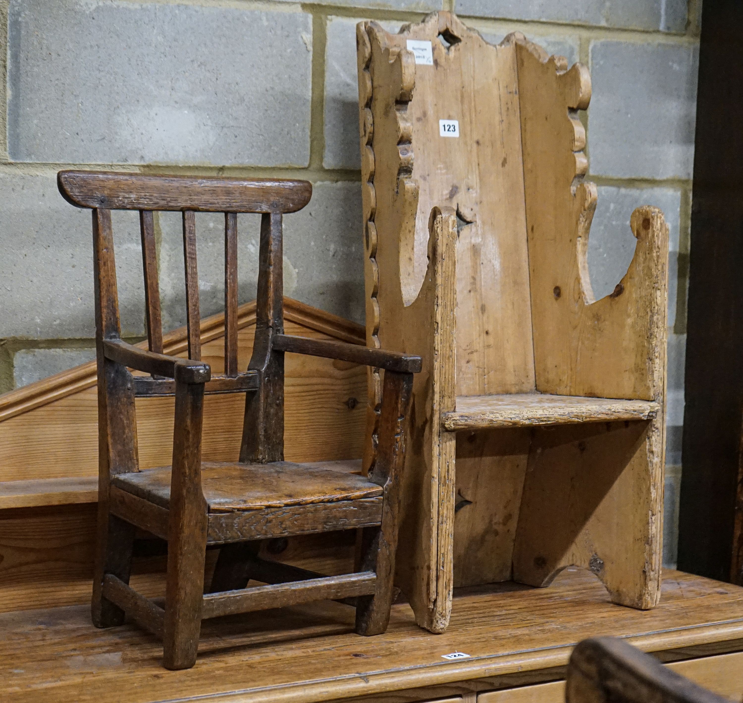 An early 19th century primitive oak child's chair with solid seat, width 39cm height 56cm and a carved pine child's chair, height 78cm